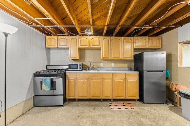 kitchen featuring unfinished concrete flooring, stainless steel appliances, a sink, and light countertops