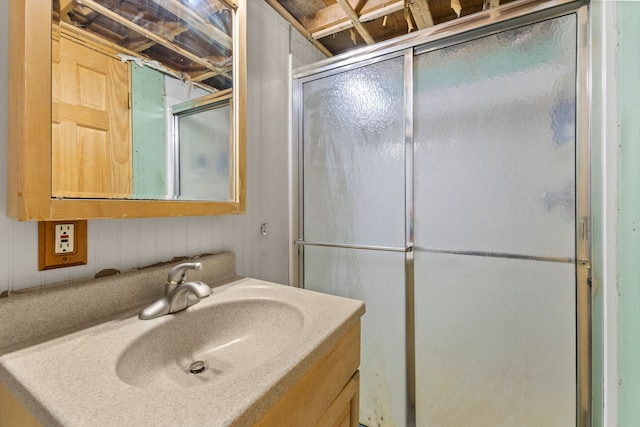 bathroom with a shower with door and vanity