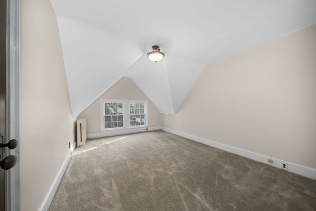 bonus room with carpet, radiator, lofted ceiling, and baseboards