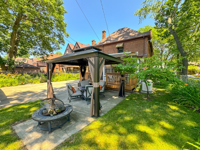 view of yard with an outdoor fire pit, fence, a patio, and a gazebo