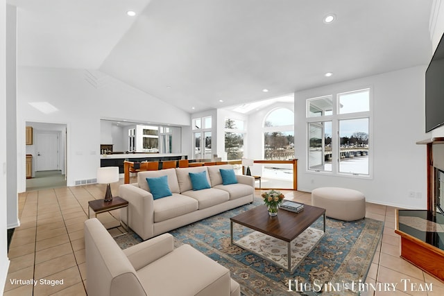 760 Bridgeview Bay Dr, Norton Shores, MI 49441 - living area featuring light tile patterned floors, recessed lighting, a fireplace, and high vaulted ceiling