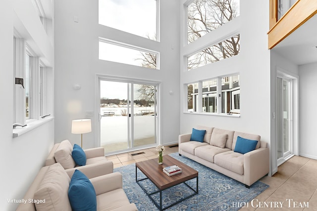 760 Bridgeview Bay Dr, Norton Shores, MI 49441 - tiled living area featuring a high ceiling and baseboards