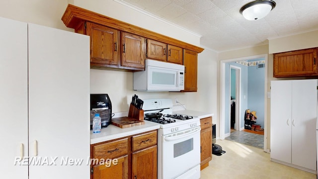 kitchen featuring brown cabinetry, white appliances, light countertops, and ornamental molding