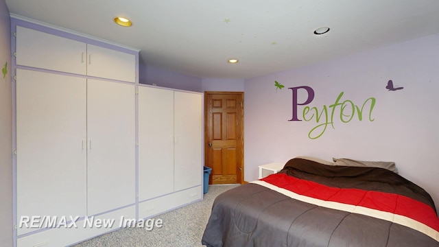 bedroom featuring light carpet and recessed lighting