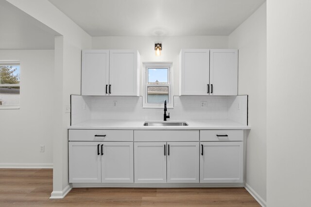 27734 Lasslett St, Roseville, MI 48066 - kitchen with decorative backsplash, a sink, and light countertops