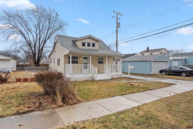 27734 Lasslett St, Roseville, MI 48066 - bungalow with a porch, an outdoor structure, fence, roof with shingles, and a front lawn