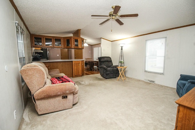 living room featuring lofted ceiling, light colored carpet, visible vents, and a textured ceiling