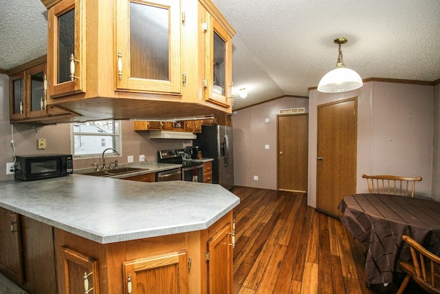 kitchen with brown cabinetry, appliances with stainless steel finishes, glass insert cabinets, decorative light fixtures, and light countertops