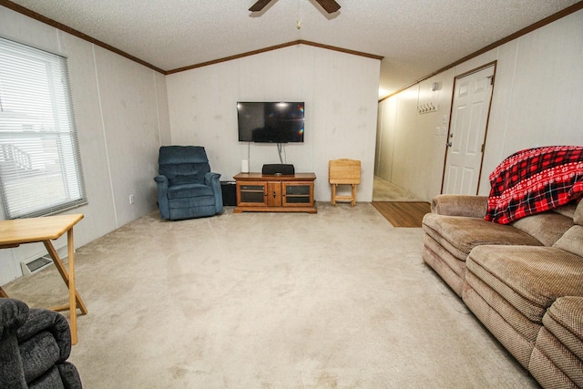 living area featuring a textured ceiling, vaulted ceiling, crown molding, and carpet flooring