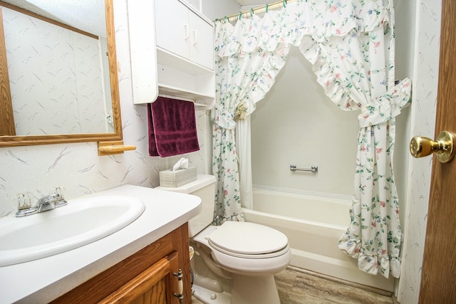 bathroom with shower / bath combo, vanity, and toilet