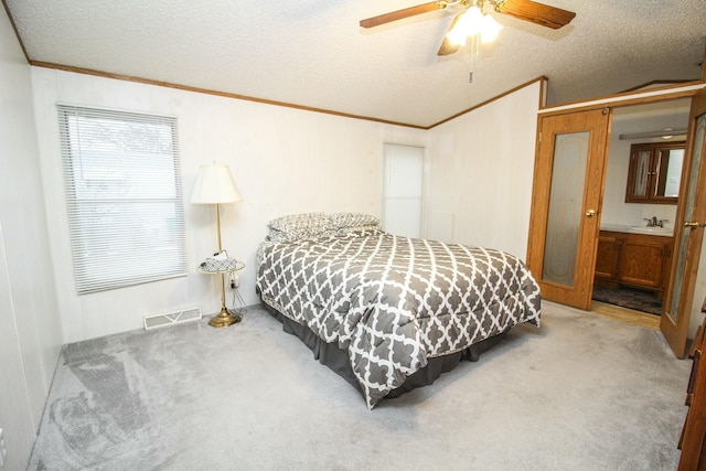 bedroom with carpet floors, visible vents, and a textured ceiling