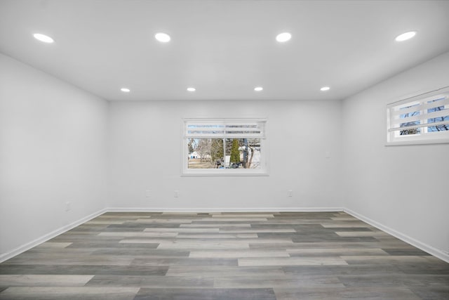 basement with a wealth of natural light, wood finished floors, and recessed lighting