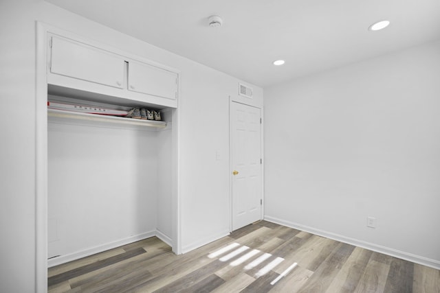 interior space featuring recessed lighting, wood finished floors, visible vents, and baseboards