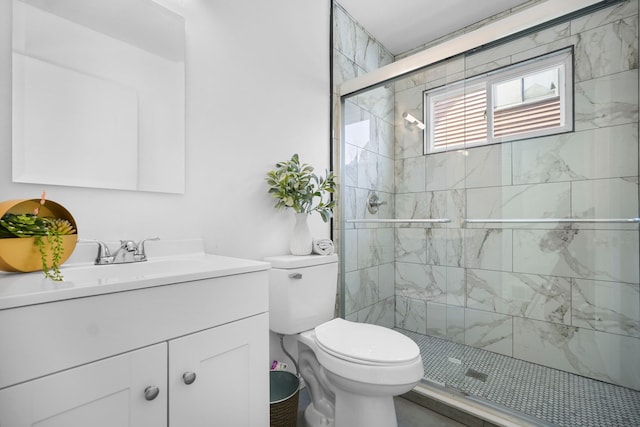 full bathroom featuring a stall shower, vanity, and toilet