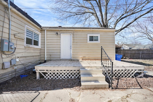 entrance to property with fence and a deck