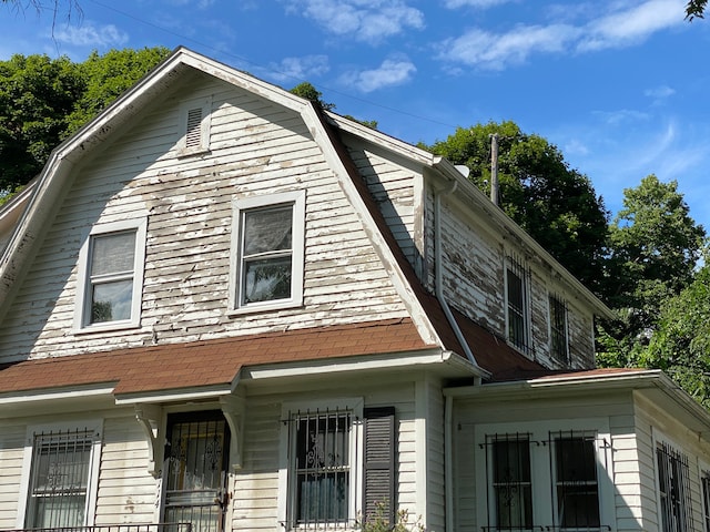 view of home's exterior with a gambrel roof