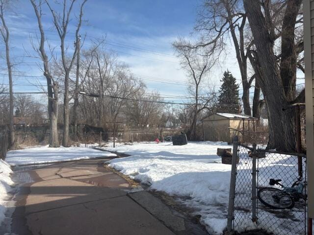 yard covered in snow with fence