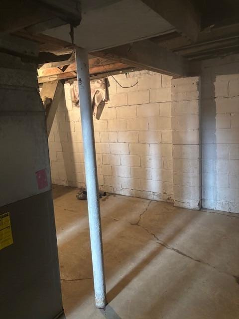 unfinished basement featuring heating unit