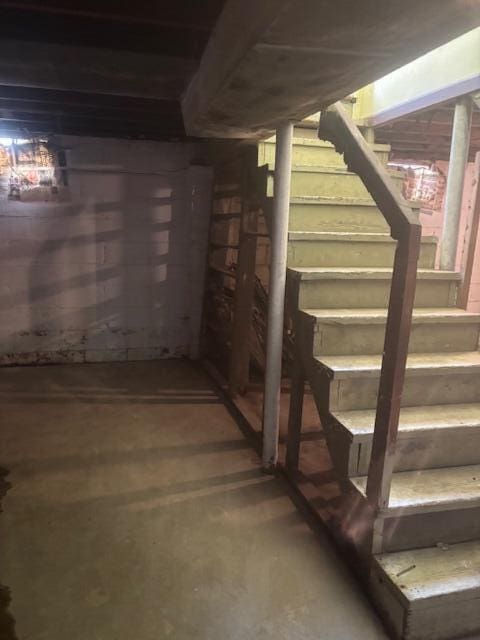 unfinished basement featuring stairway