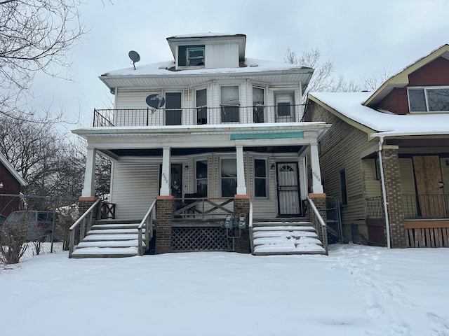 american foursquare style home with covered porch and a balcony