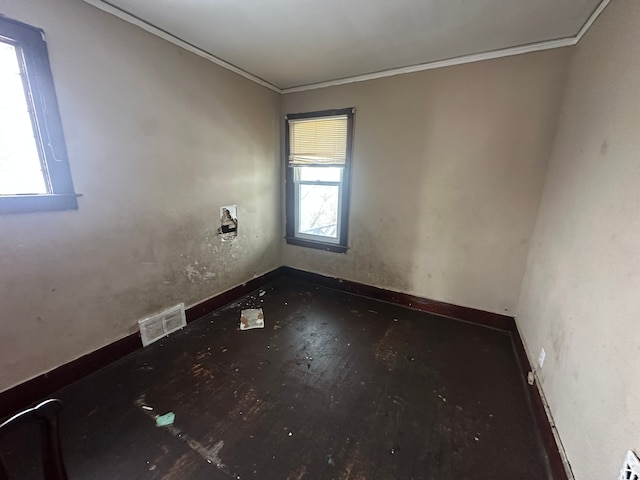 unfurnished room featuring visible vents and crown molding