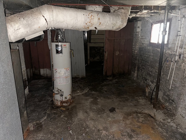 unfinished below grade area featuring water heater