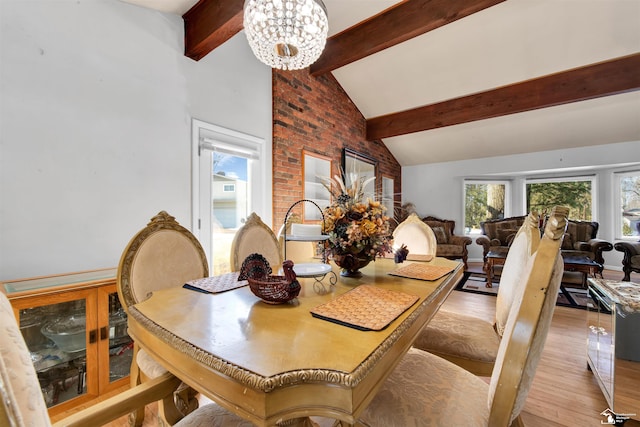 dining room featuring high vaulted ceiling, light wood-type flooring, beam ceiling, and a notable chandelier