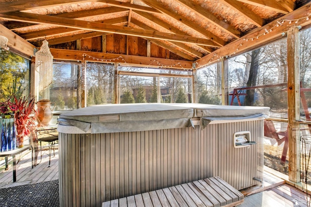 unfurnished sunroom featuring vaulted ceiling