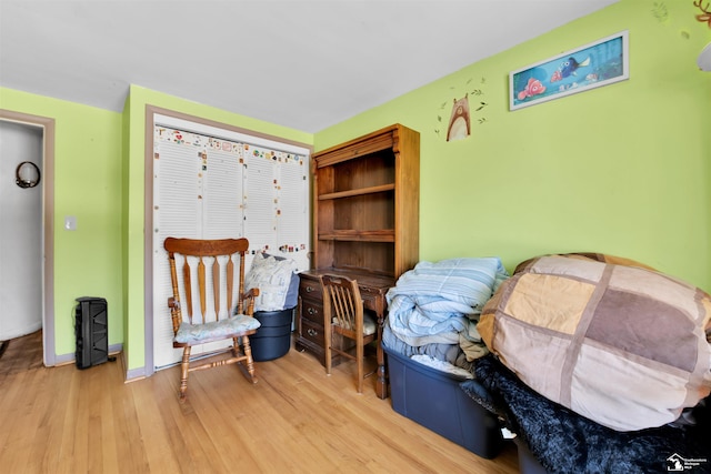 living area featuring light wood-style floors and baseboards