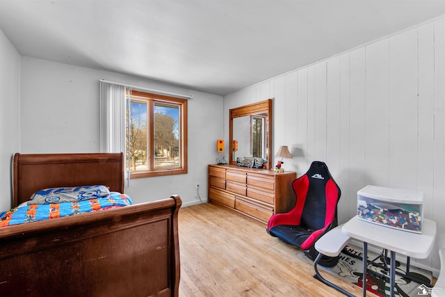 bedroom featuring wood finished floors and baseboards