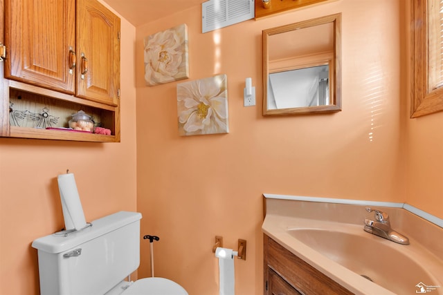 bathroom featuring toilet and vanity