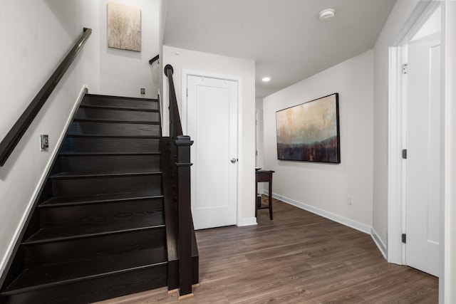 staircase with recessed lighting, baseboards, and wood finished floors