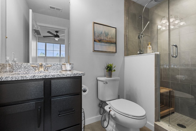 bathroom with toilet, a shower stall, visible vents, and vanity