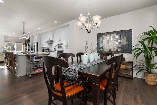 dining room featuring dark wood-style floors, recessed lighting, and a notable chandelier