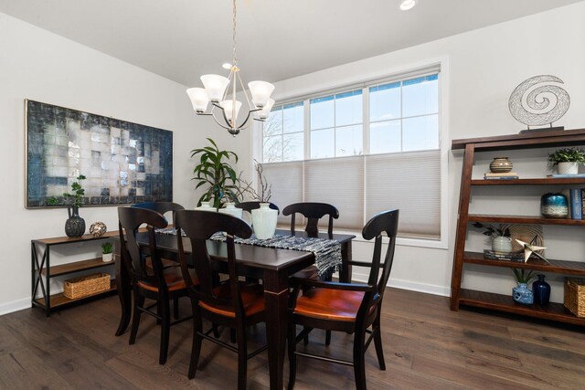 dining area featuring baseboards, a chandelier, and dark wood-type flooring