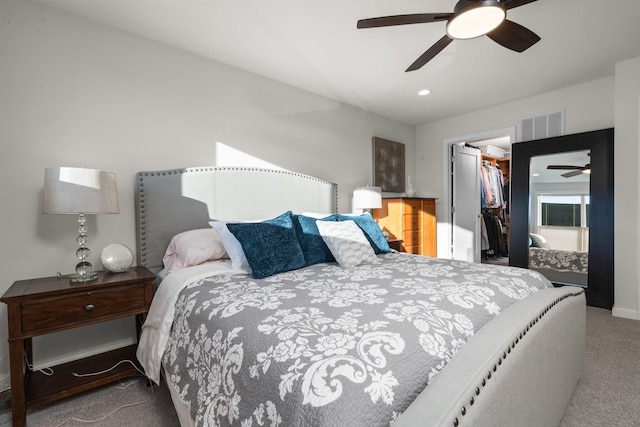 bedroom with visible vents, a ceiling fan, a spacious closet, carpet flooring, and a closet