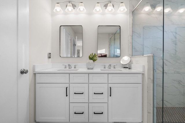 bathroom featuring double vanity, a sink, and a marble finish shower