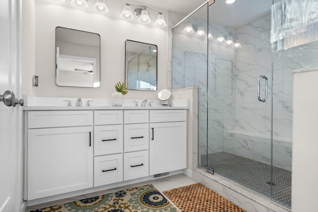 bathroom with a sink, marble finish floor, double vanity, and a marble finish shower