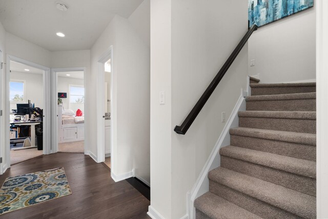 staircase featuring recessed lighting, baseboards, and wood finished floors