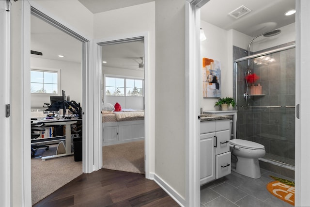 ensuite bathroom with vanity, a stall shower, ensuite bath, and visible vents