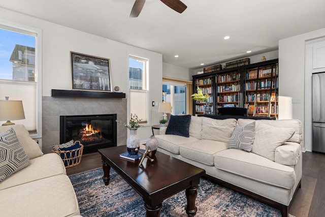 living room with recessed lighting, a ceiling fan, wood finished floors, and a tile fireplace