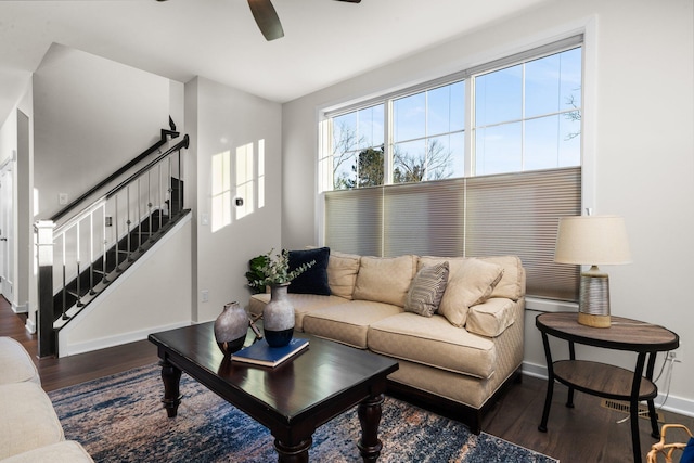 living area with ceiling fan, stairs, baseboards, and wood finished floors