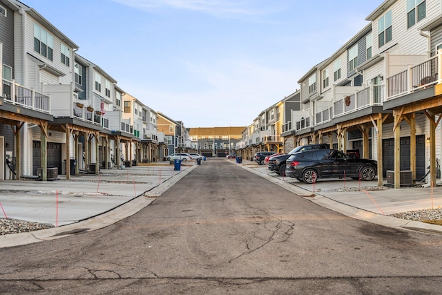 view of road featuring a residential view and curbs