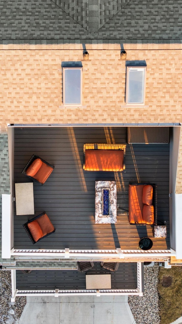 exterior space featuring mansard roof and roof with shingles