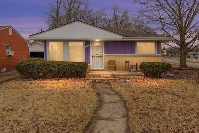 view of front of house featuring covered porch and brick siding