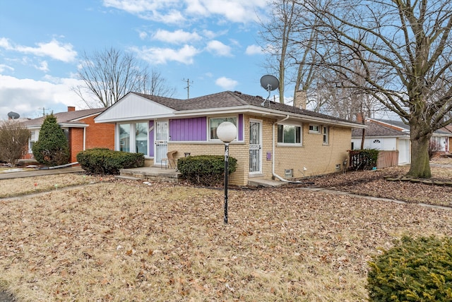 single story home featuring entry steps and brick siding