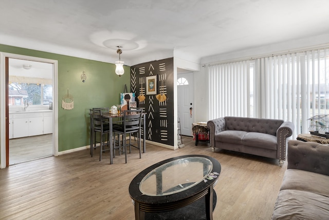 living area with wood finished floors and baseboards