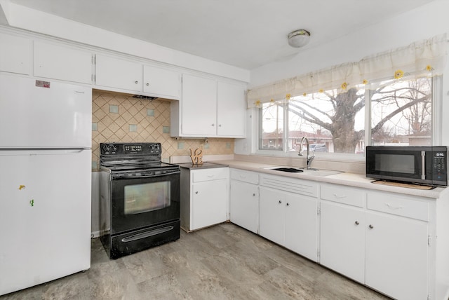 kitchen featuring a sink, white cabinets, light countertops, backsplash, and black appliances