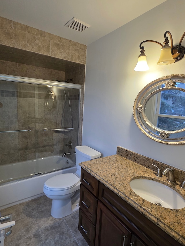 bathroom with tile patterned flooring, toilet, visible vents, vanity, and combined bath / shower with glass door