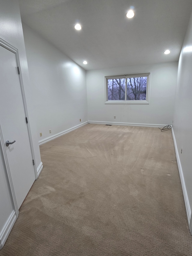 basement featuring recessed lighting, light colored carpet, visible vents, and baseboards